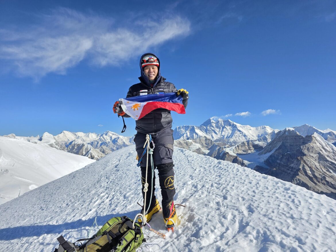 Jeno Panganiban brandishes the Philippine flag at Mera Peak in Nepal, which offers a view of Mount Everest.